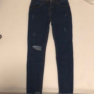 Ripped dark blue jeans never worn